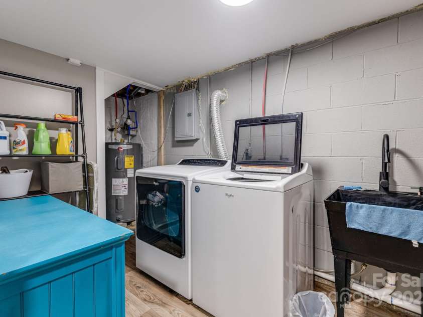 57 Maplewood Knoll Drive, East Flat Rock, NC 28726.  MLS# CAR4239967, YatesRealty ID 6497. Lower level laundry room.