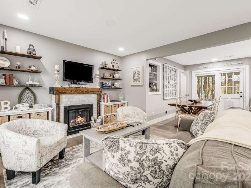 57 Maplewood Knoll Drive, East Flat Rock, NC 28726.  MLS# CAR4239967, YatesRealty ID 6497. Main level living room.
