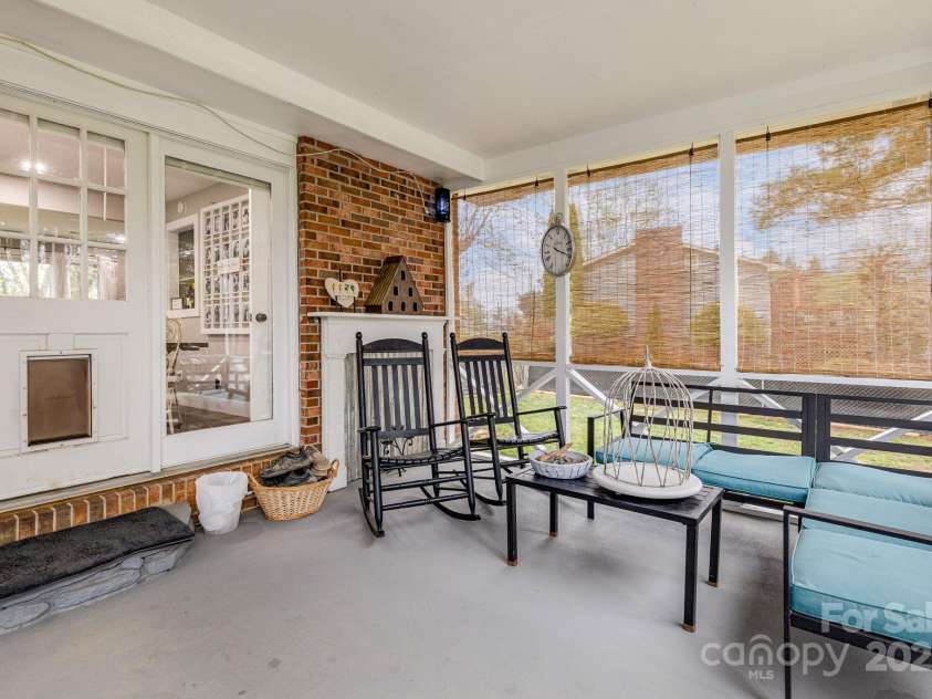 57 Maplewood Knoll Drive, East Flat Rock, NC 28726.  MLS# CAR4239967, YatesRealty ID 6497. Step down to a lovely screened-in porch.