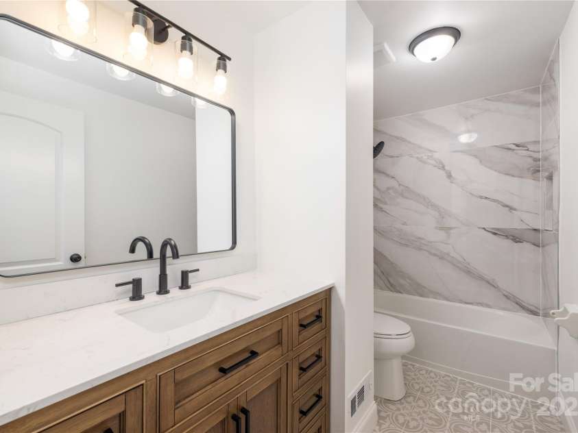 4836 Cheviot Road, Charlotte, NC 28269.  MLS# CAR4228471, YatesRealty ID 6503. Beautiful full bathroom with luxury tile and finishes