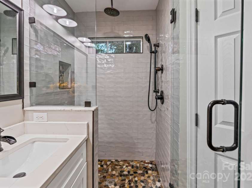 2117 Camp Greene Street, Charlotte, NC 28208.  MLS# CAR4241188, YatesRealty ID 6504. Walk-in shower enhances the experience in primary bathroom.