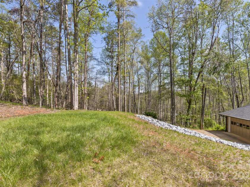 3474 Crestwood Drive, Morganton, NC 28655.  MLS# CAR4245149, YatesRealty ID 6508. Open back yard surrounded by woods.