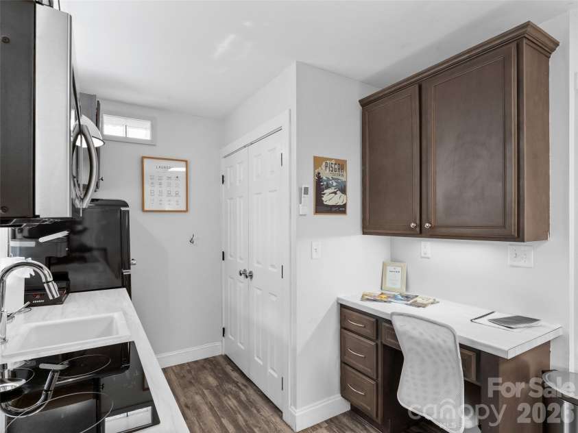 175 Duckworth Avenue, Brevard, NC 28712.  MLS# CAR4361938, YatesRealty ID 6539. Unit B - Kitchen, Washer/Dryer, and Workspace