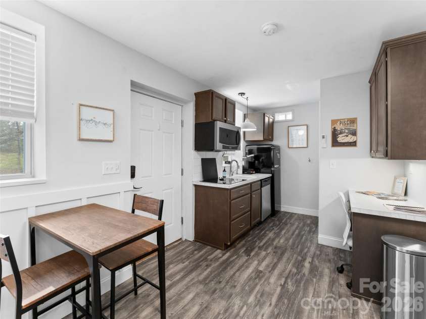 175 Duckworth Avenue, Brevard, NC 28712.  MLS# CAR4361938, YatesRealty ID 6539. Unit B - Kitchen, Washer/Dryer, Workspace, and Dining Area
