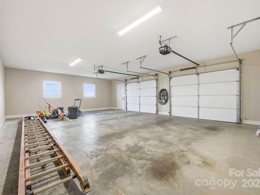 38 Sweetwater Oaks Drive, Fletcher, NC 28732.  MLS# CAR4331629, YatesRealty ID 654. 2 car attached garage on the lower level