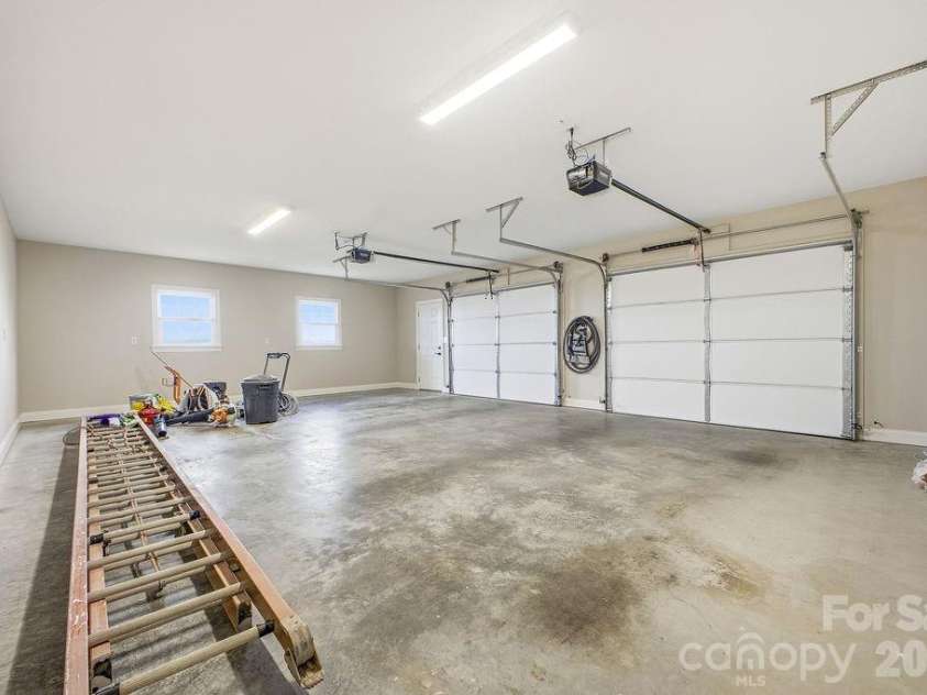 38 Sweetwater Oaks Drive, Fletcher, NC 28732.  MLS# CAR4331629, YatesRealty ID 654. 2 car attached garage on the lower level