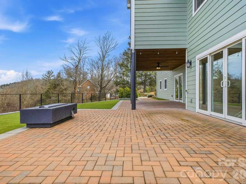 38 Sweetwater Oaks Drive, Fletcher, NC 28732.  MLS# CAR4331629, YatesRealty ID 654. Lower level patio and turf