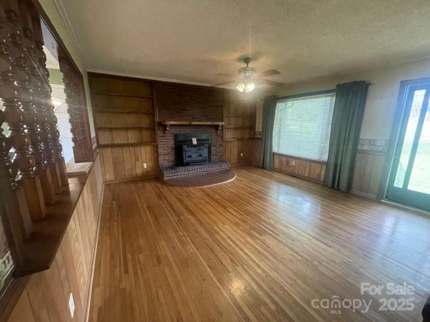1620 Moss Springs Road, Albemarle, NC 28001.  MLS# CAR4248855, YatesRealty ID 6544. Living room.. in its current condition with beautiful hardwood floors