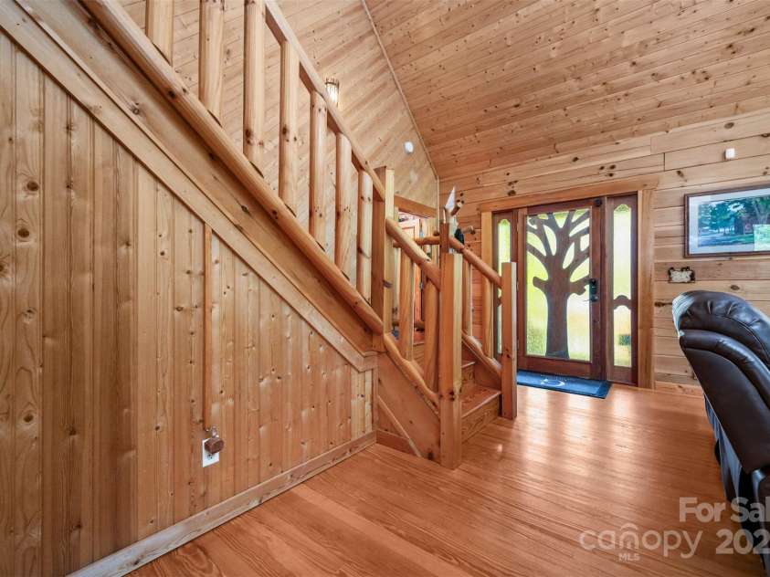 145 Flynn Court, Lake Lure, NC 28746.  MLS# CAR4247802, YatesRealty ID 6548. Foyer and stairs leading to the guest bedroom and loft