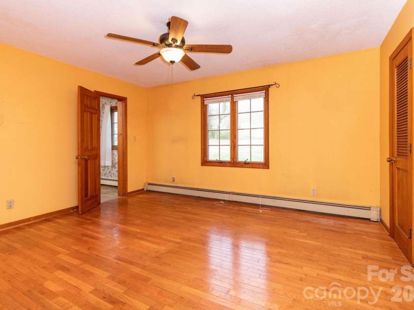 586 Justice Ridge Road, Candler, NC 28715.  MLS# CAR4359252, YatesRealty ID 6562. Primary Bedroom