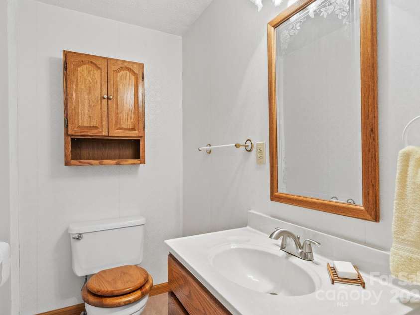 2767 Tanasee Gap Road, Balsam Grove, NC 28708.  MLS# CAR4161160, YatesRealty ID 6567. 1/2 bath off kitchen and back door entry