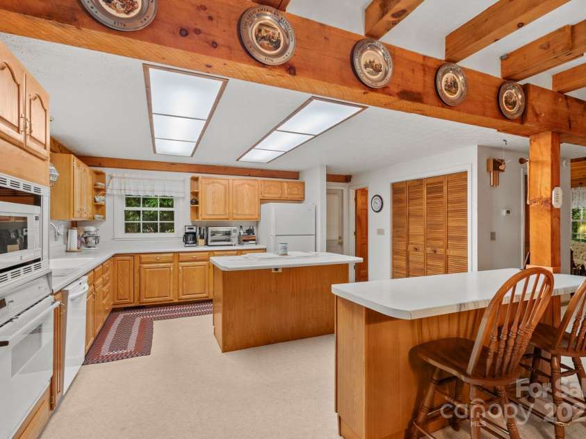 2767 Tanasee Gap Road, Balsam Grove, NC 28708.  MLS# CAR4161160, YatesRealty ID 6567. Kitchen and eating bar