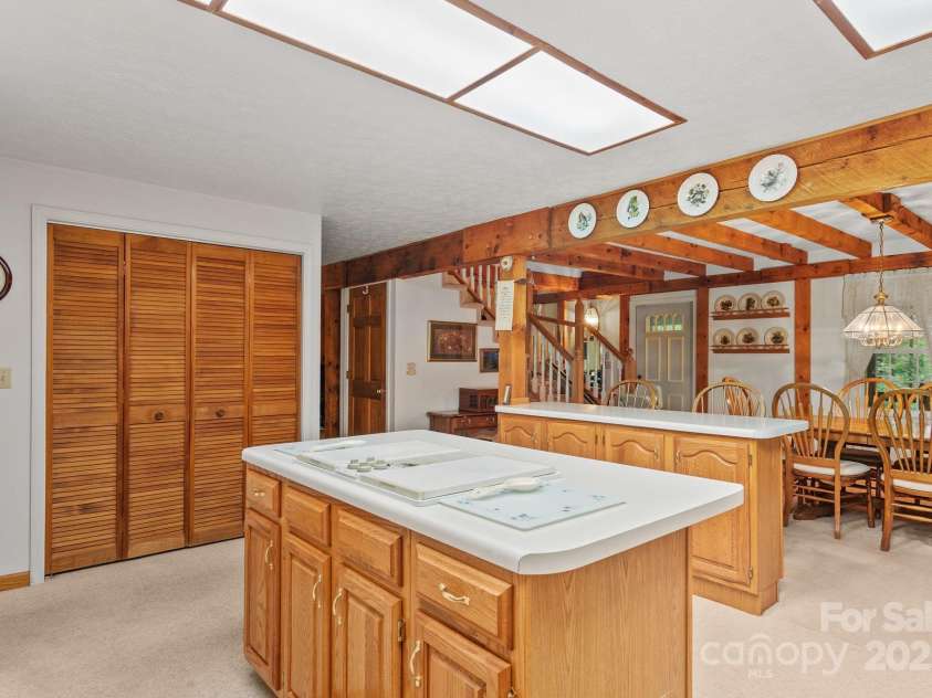 2767 Tanasee Gap Road, Balsam Grove, NC 28708.  MLS# CAR4161160, YatesRealty ID 6567. Kitchen opens to dining room