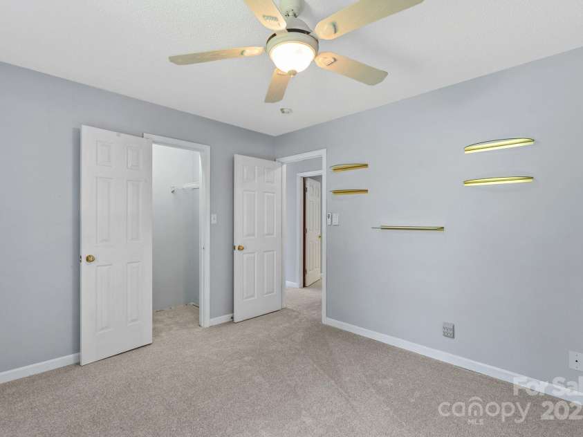 27 Eden Glen Road, Black Mountain, NC 28711.  MLS# CAR4292054, YatesRealty ID 6572. A bright and versatile bedroom complete with ceiling fan and ample closet space.