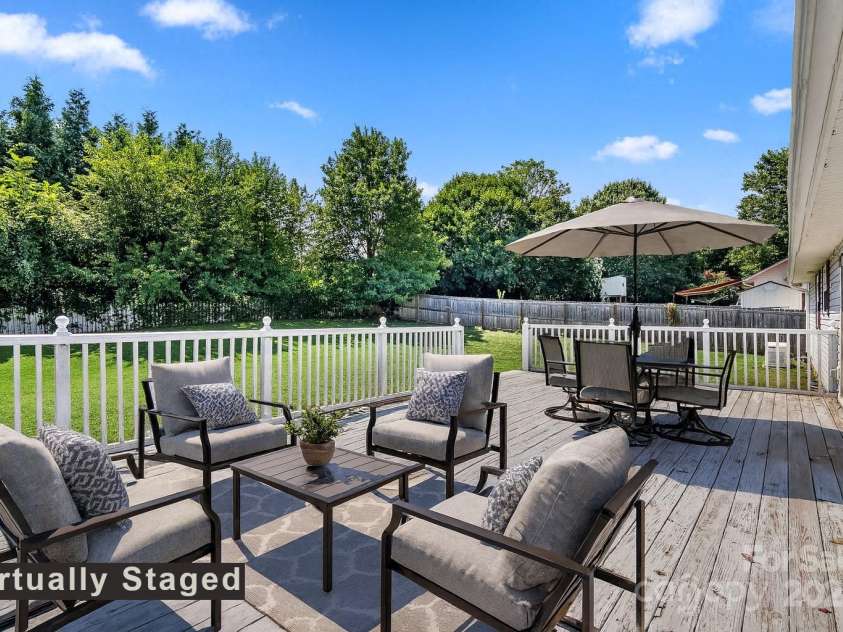 27 Eden Glen Road, Black Mountain, NC 28711.  MLS# CAR4292054, YatesRealty ID 6572. A large deck overlooking a level backyard—ideal for gatherings big or small.