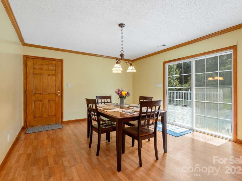 27 Eden Glen Road, Black Mountain, NC 28711.  MLS# CAR4292054, YatesRealty ID 6572. Bright dining area with sliding glass doors that open to the back deck for easy indoor-outdoor living.