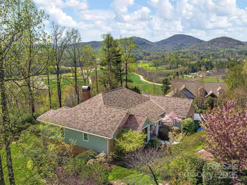 125 Lindsley Court, Hendersonville, NC 28792.  MLS# CAR4245651, YatesRealty ID 6574. Aerial of home with mountains in the background