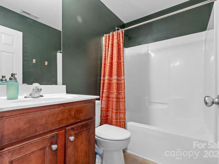 3028 Summerfield Ridge Lane, Matthews, NC 28105.  MLS# CAR4219617, YatesRealty ID 6596. Second bath-- backs to the primary, so these could be reimagined by a creative buyer without moving any plumbing!