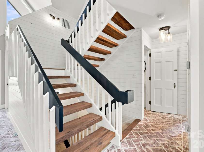 155 Winding Meadows Drive, Flat Rock, NC 28731.  MLS# CAR4418480, YatesRealty ID 6600. Custom built floating stairs to the upper level