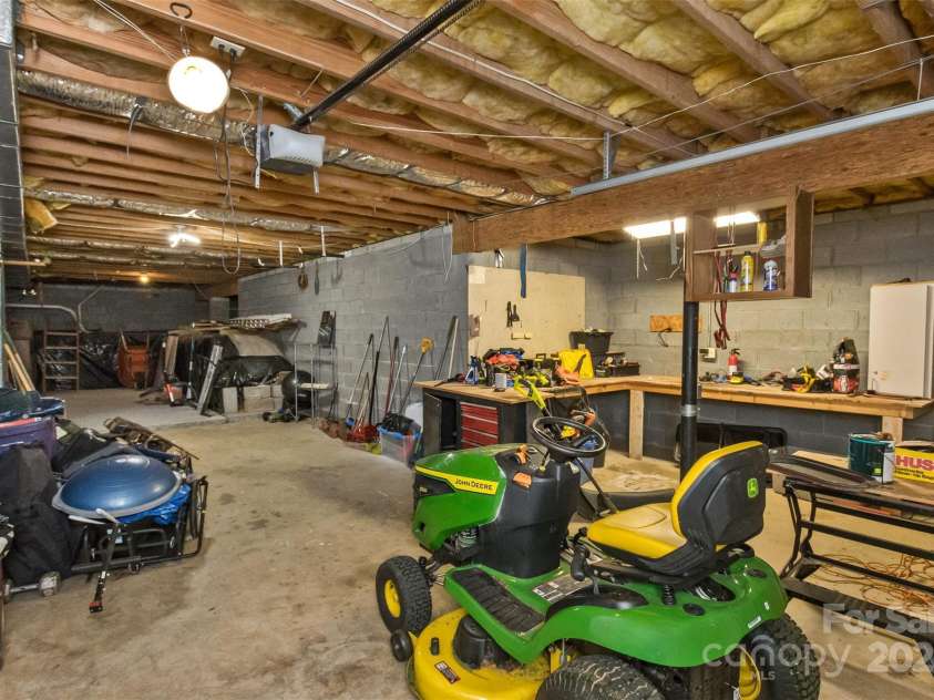 147 Canaan Drive, Candler, NC 28715.  MLS# CAR4248195, YatesRealty ID 6658. Basement Workshop and Garage.