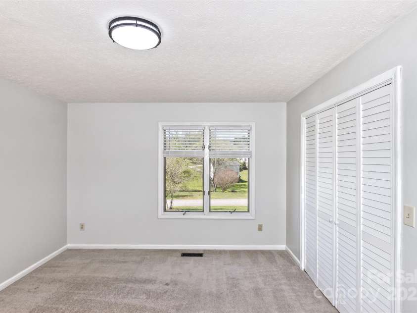 147 Canaan Drive, Candler, NC 28715.  MLS# CAR4248195, YatesRealty ID 6658. Bedroom One.