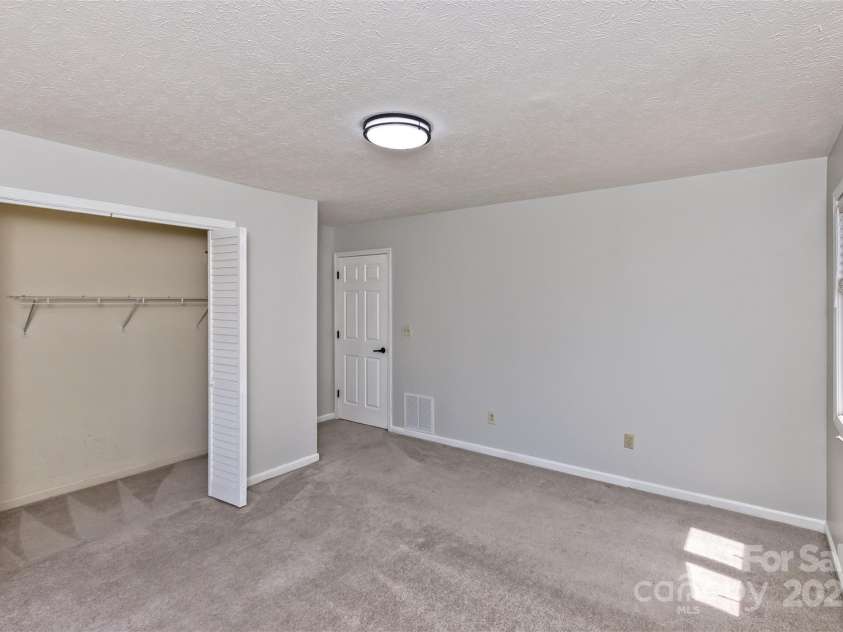 147 Canaan Drive, Candler, NC 28715.  MLS# CAR4248195, YatesRealty ID 6658. Bedroom One.