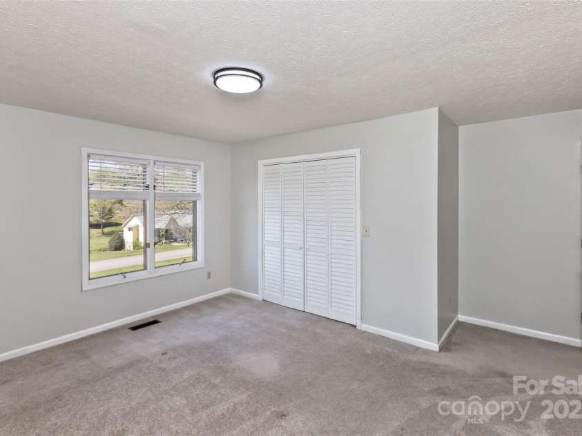 147 Canaan Drive, Candler, NC 28715.  MLS# CAR4248195, YatesRealty ID 6658. Bedroom One.