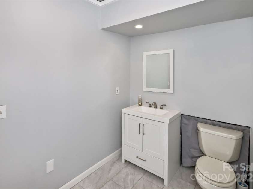 147 Canaan Drive, Candler, NC 28715.  MLS# CAR4248195, YatesRealty ID 6658. Downstairs Half Bath.