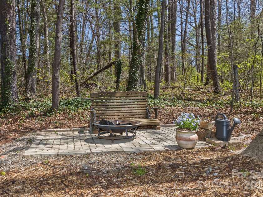 147 Canaan Drive, Candler, NC 28715.  MLS# CAR4248195, YatesRealty ID 6658. Rear fire-pit.