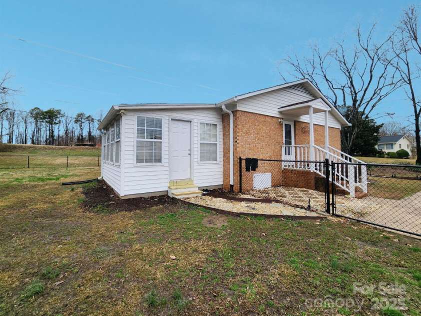 114 Eller Road, Gastonia, NC 28056.  MLS# CAR4222623, YatesRealty ID 6663. Sunroom with outside access to fenced area