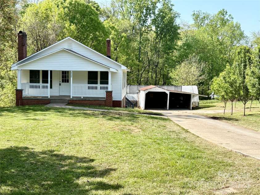 2724 Peachtree Road, Statesville, NC 28625.  MLS# CAR4248826, YatesRealty ID 6676. Adorable in-town bungalow with peach orchard, greenhouse, basement and carport!