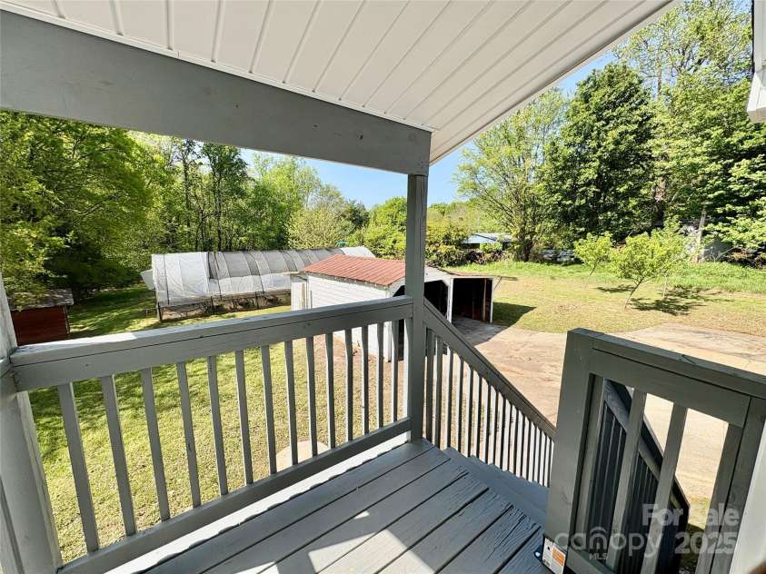 2724 Peachtree Road, Statesville, NC 28625.  MLS# CAR4248826, YatesRealty ID 6676. Small covered deck with steps leads to carport/back yard!