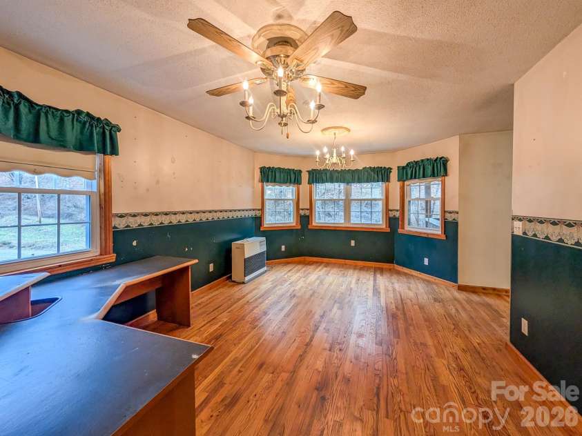 77 Griffith Branch Road, Green Mountain, NC 28740.  MLS# CAR4328405, YatesRealty ID 668. Den/Flex space offers verstility for additional living area, den, dining room, office - whatever you might decide to utilize it for. Featuring hardwood flooring and kerosene monitor for supplemental heat source.