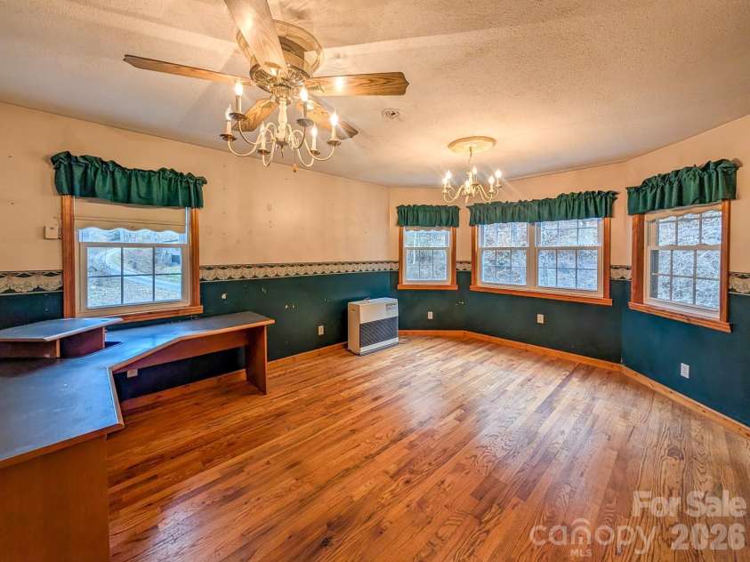 77 Griffith Branch Road, Green Mountain, NC 28740.  MLS# CAR4328405, YatesRealty ID 668. Den/Flex space offers verstility for additional living area, den, dining room, office - whatever you might decide to utilize it for. Featuring hardwood flooring and kerosene monitor for supplemental heat source.