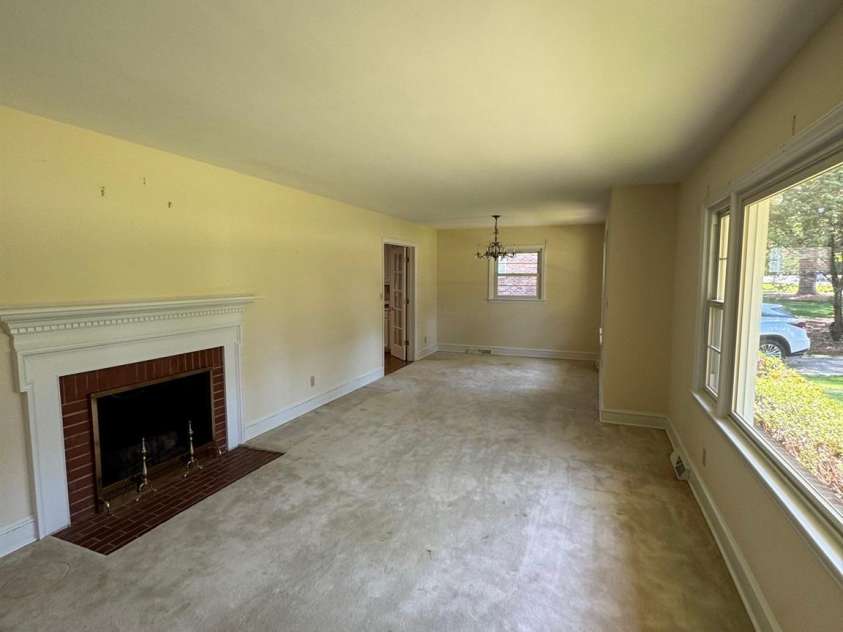 5119 Beckford Drive, Charlotte, NC 28226.  MLS# CAR4247630, YatesRealty ID 6706. As you step into the foyer, you are greeted by a spacious living and dining room area, highlighted by a large picture window overlooking the tree-lined street. Beneath the carpeting, beautiful hardwood floors are waitin