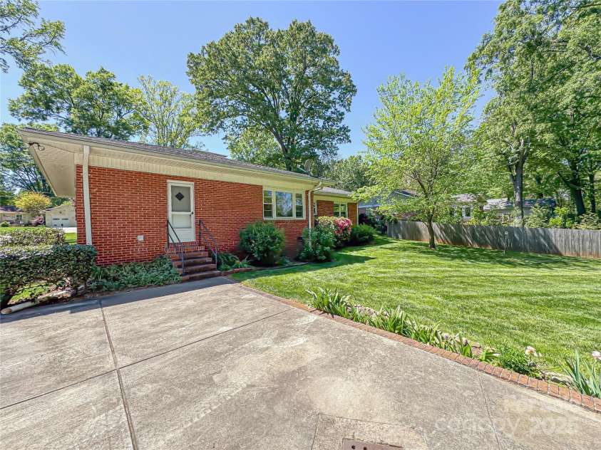 5119 Beckford Drive, Charlotte, NC 28226.  MLS# CAR4247630, YatesRealty ID 6706. Rear view of the home with beautiful landscaping! The home is ready for your imagination.
