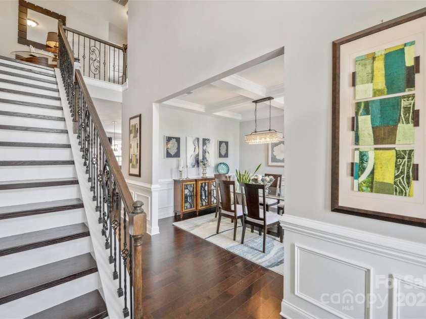 4607 Bonroi Avenue, Charlotte, NC 28213.  MLS# CAR4248280, YatesRealty ID 6713. From the front door walk in to an incredible view of the beautiful hardwood floors and upgraded staircase and iron railing and view of the formal dining room.