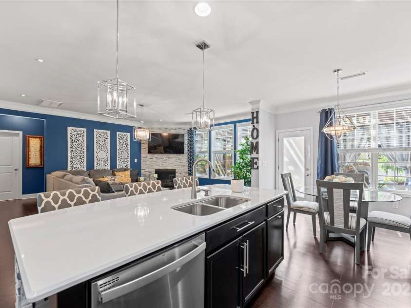 4607 Bonroi Avenue, Charlotte, NC 28213.  MLS# CAR4248280, YatesRealty ID 6713. From the kitchen this large island has custom stone at the bar stool area that matches the stone on the fireplace.  Check out the view from the breakfast window of the extra living area just outside the window overlookin