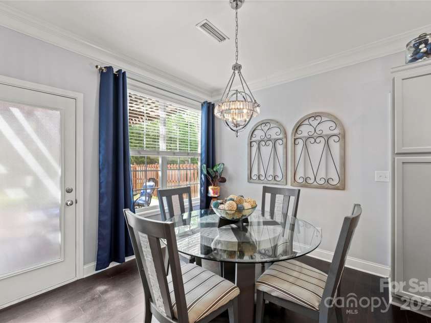 4607 Bonroi Avenue, Charlotte, NC 28213.  MLS# CAR4248280, YatesRealty ID 6713. In the breakfast area just off the kitchen and living room shows off the grand space as well as high end lighting.  Have your morning coffee then head out to the outdoor living space just outside the door.