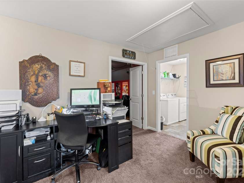 4607 Bonroi Avenue, Charlotte, NC 28213.  MLS# CAR4248280, YatesRealty ID 6713. This picture features a closer look at the area the sellers are using as an office space.  The access to the attic is here in this space and shows the pull down access to the attic.