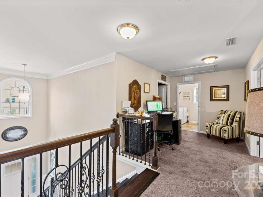 4607 Bonroi Avenue, Charlotte, NC 28213.  MLS# CAR4248280, YatesRealty ID 6713. Walking upstairs you will find a large landing that connects all of the upstairs rooms.  The primary suite is to the right the laundry room is straight ahead and the bonus/theater room is to the left.  behind you in this