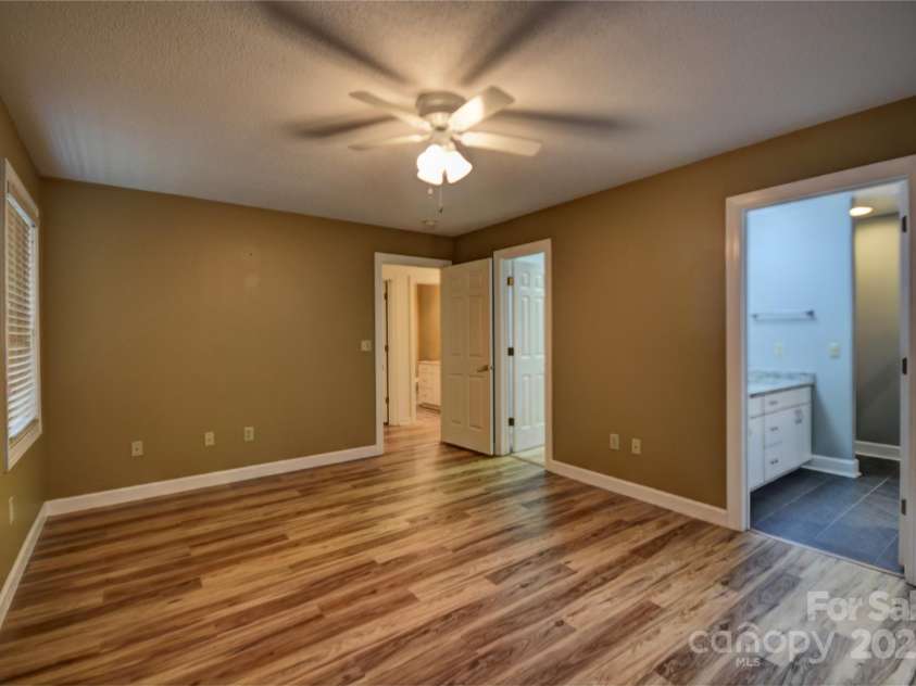 1465 Lakeshore Drive, Lake Junaluska, NC 28745.  MLS# CAR4241978, YatesRealty ID 6718. Alternate photo of the primary BR, primary bath and large walk in closet to the right