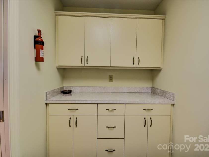 1465 Lakeshore Drive, Lake Junaluska, NC 28745.  MLS# CAR4241978, YatesRealty ID 6718. Cabinets in the laundry room adjacent to the kitchen