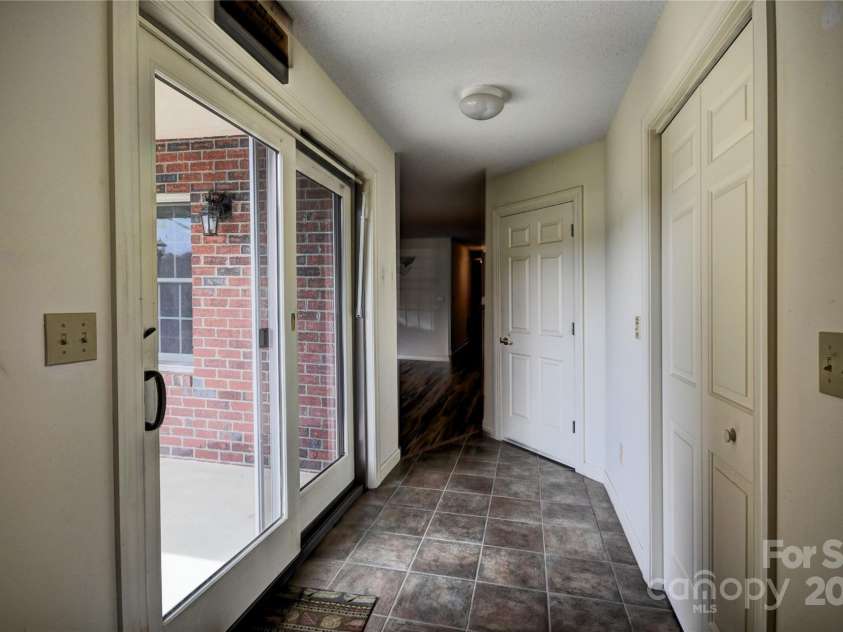 1465 Lakeshore Drive, Lake Junaluska, NC 28745.  MLS# CAR4241978, YatesRealty ID 6718. Front Hallway, closet to the left and a large mechanical clloset with the air handler and water heater