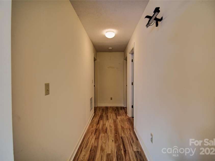 1465 Lakeshore Drive, Lake Junaluska, NC 28745.  MLS# CAR4241978, YatesRealty ID 6718. Hallway to the bedrooms and baths