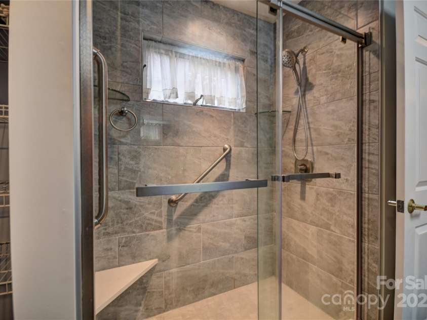 1465 Lakeshore Drive, Lake Junaluska, NC 28745.  MLS# CAR4241978, YatesRealty ID 6718. Walk-in Shower with glass doors in the primary bath
