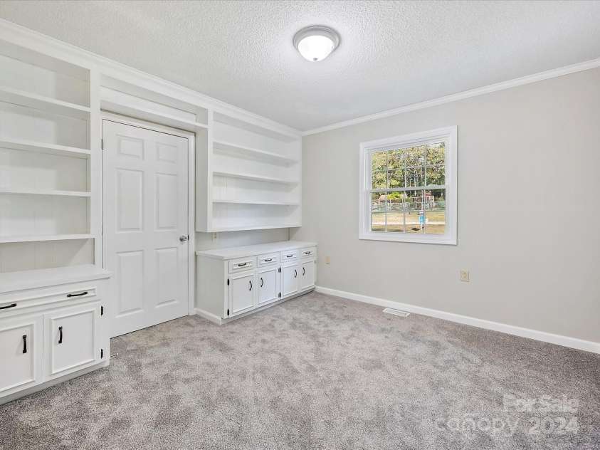 111 Bobby Lee Lane, Mooresville, NC 28115.  MLS# CAR4127085, YatesRealty ID 6728. Bedroom 2 with Built-in Bookshelves with walk-in closet