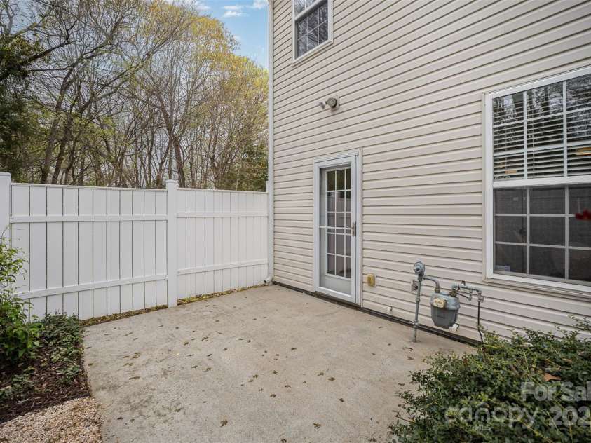 7445 Abigail Glen Drive, Charlotte, NC 28212.  MLS# CAR4242809, YatesRealty ID 6737. Fenced Patio w/perennial garden.