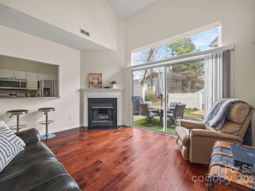 8830 Cinnabay Drive, Charlotte, NC 28216.  MLS# CAR4227249, YatesRealty ID 6758. Living room with gas fireplace