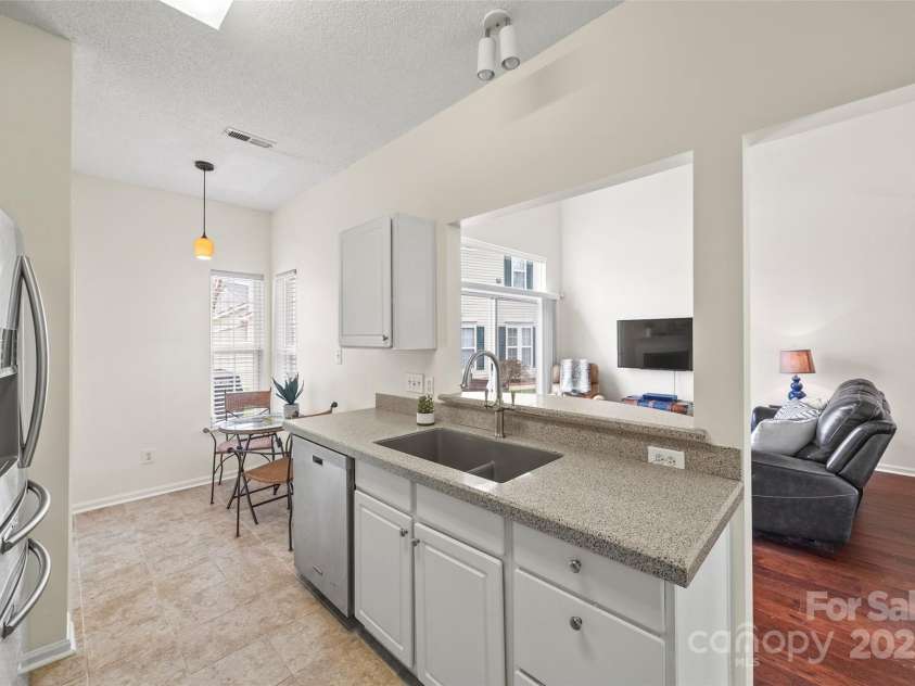8830 Cinnabay Drive, Charlotte, NC 28216.  MLS# CAR4227249, YatesRealty ID 6758. Pass-through window features quartz breakfast bar for convenience